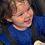 toddler, child, smiling, curly_hair, blue_dress, car_seat, seatbelt, happy, face, portrait, baby, indoor, clothing, person, cute, young_child, closeup, emotion, joy, safety