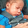 baby, sleeping, car_seat, safety_harness, blue_shirt, child, infant, hand, tattoo, resting, closeup, person, seatbelt, protection, peaceful, cute, young_child, indoor, portrait, skin