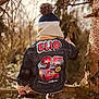 autumn, back_view, beanie, cartoon_patch, casual_wear, child, clothing, colorful, denim_jacket, forest, jackets, kid, nature, outdoor, park, playful, seasonal, tree_branch, winter_hat, young