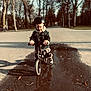 Elio participe au concours pour gagner de l'argent avec cette photo : autumn, balance_bike, bike, child, daylight, denim_jacket, footwear, helmet, leaves, nature, outdoor, park, path, person, puddle, reflection, road, shadow, toddler, trees