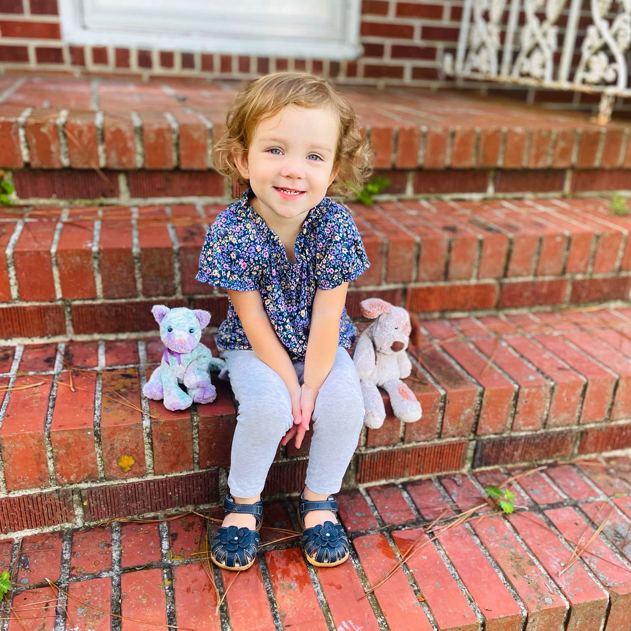 Genevieve joined the competition — help win amazing prizes! baby_toddler_clothing, brick, brickwork, child, flooring, footwear, fun, grass, happy, joy, leisure, orange, pattern, person, sitting, sleeve, smile, sneakers, stairs, t_shirt