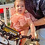baby, bodypart, clothing, dynamite, e_scooter, face, finger, hand, head, helmet, motorcycle, person, photography, portrait, shorts, summer, t_shirt, transportation, vehicle, weapon