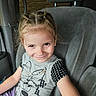child, girl, braided_hair, smile, car_seat, seatbelt, clothing, tshirt, minnie_mouse, polka_dots, purple_pants, vehicle_interior, window, seat_headrest, happy, casual, portrait, cute, young, playful
