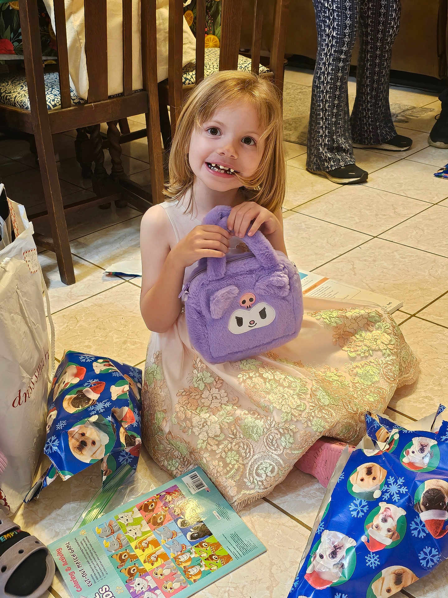 Mattie joined the competition — help win amazing prizes! activity_sheet, background, child, dog_print, dress, floor, furniture, gift_wrap, girl, handbag, happy, indoor, legs, person, presents, purple_bag, shoes, smile, tile_floor, toy