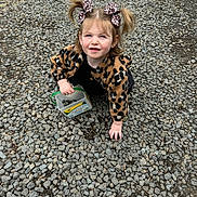 Phoebe joined the competition — help win amazing prizes! toddler, child, girl, leopard_print, hair_bows, jacket, gravel, sidewalk_chalk, container, outdoor, crouching, smiling, cute, playful, person, young_child, daylight, fashion, ground, nature