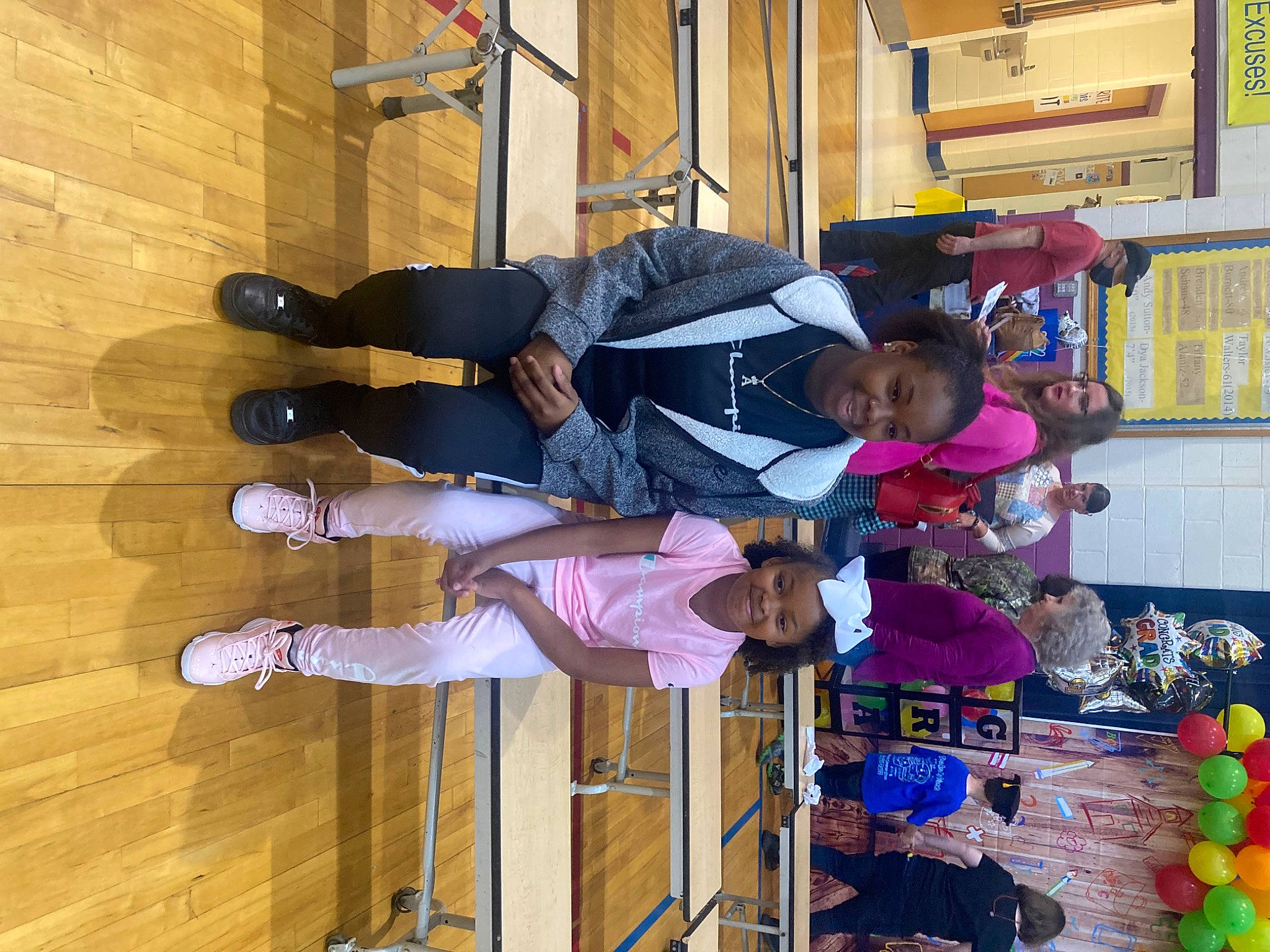 Messiah is registered to the contest to win money with this photo: balloon, building, event, fun, hardwood, joy, kindergarten, outdoor_shoe, party_supply, person, room, shelf, smile, toddler, varnish, walking_shoe, wood