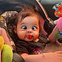 Marisol is registered to the contest to win money with this photo: baby, bracelet, car_interior, car_seat, child, clothing, crossed_eyes, cute, daylight, expression, face, funny_face, hair, infant, playful, seatbelt, side_mirror, tongue_out, toy, window