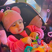 Marisol joined the competition — help win amazing prizes! baby, pink_hat, pom_poms, car_seat, toy, colorful_toy, pink_sweater, blanket, indoor, child, cute, sparkles, hearts, playful, infant, seated, warm_clothing, focus, adorable, cozy