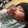 Yael joined the competition — help win amazing prizes! baby, child, face, hand, finger, beanie, hat, sleeping, cozy, blanket, indoor, clothing, cute, peaceful, infant, portrait, closeup, young, person, resting