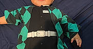 Yael is registered to the contest to win money with this photo: baby, baby_boy, baby_girl, black_clothing, casual, child, clothing, cute, dark_background, face, green_clothing, happy, indoor, infant, lying_down, one_person, patterned_clothing, portrait, smile, young_child