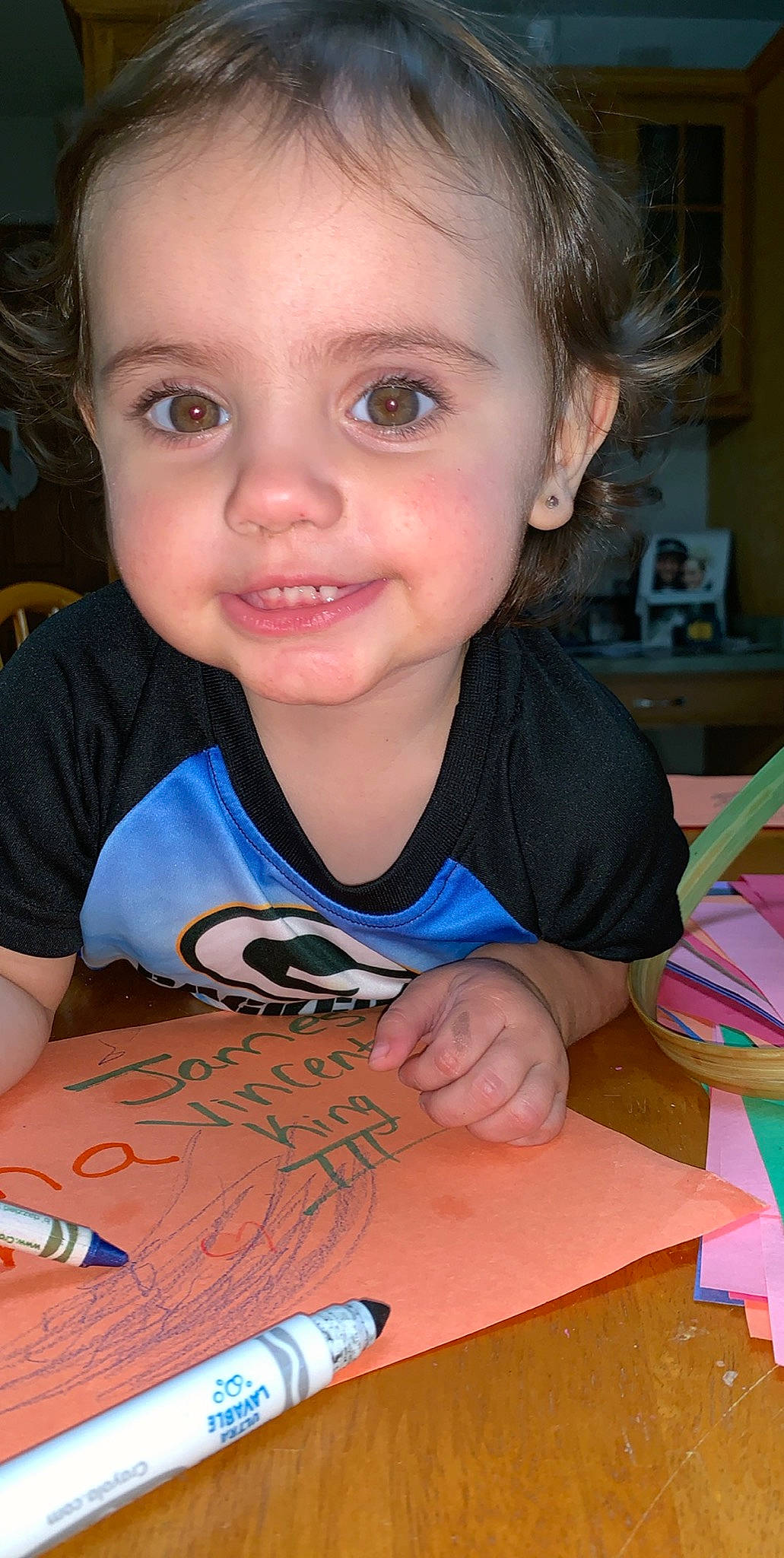 Gianna is registered to the contest to win money with this photo: child, face, homework, learning, person, play, smile, toddler, writing_implement, writing_instrument_accessory