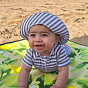 Jude participe au concours pour gagner de l'argent avec cette photo : baby, beach, blanket, bucket, child, crawling, happy, hat, ocean, outdoor, play, sand, shovel, smiling, striped_clothing, summer, sun_hat, toy, water, waves