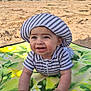baby, beach, blanket, bucket, child, crawling, happy, hat, ocean, outdoor, play, sand, shovel, smiling, striped_clothing, summer, sun_hat, toy, water, waves