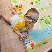 Adrien participe au concours pour gagner de l'argent avec cette photo : animal_print, baby, child, colorful, crawling, cute, floor, floor_tiles, fun, glasses, happy, indoor, play_mat, playtime, smile, toddler, toy, white_shorts, yellow_shirt, young_child