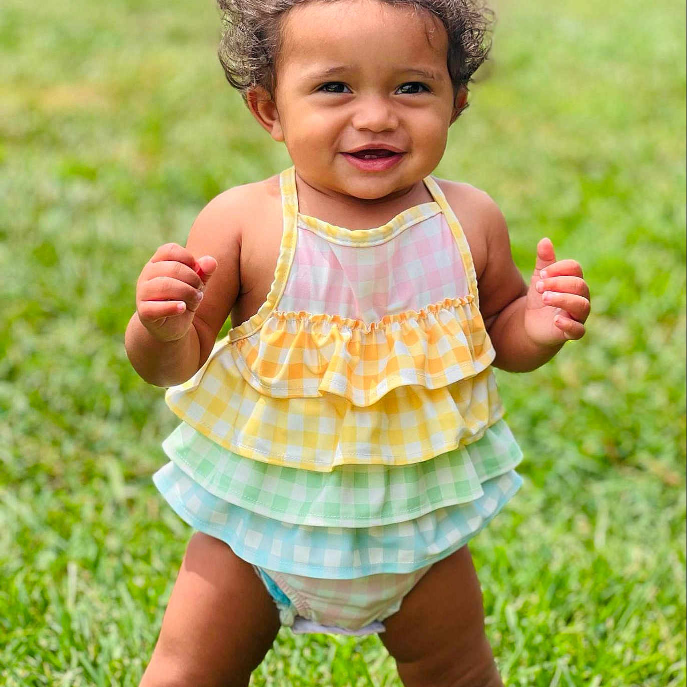 Naomi is registered to the contest to win money with this photo: baby, babylaughing, backyard, bodypart, clothing, dress, face, finger, grass, hair, hand, happy, head, lawn, person, photography, plant, portrait, sitting, smile