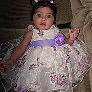 Valery Escobar joined the competition — help win amazing prizes! baby, child, girl, dress, pigtails, purple_flower, couch, white_tights, cute, portrait, indoors, smiling, person, infant, fashion, seated, young_child, happy, plush, clothing