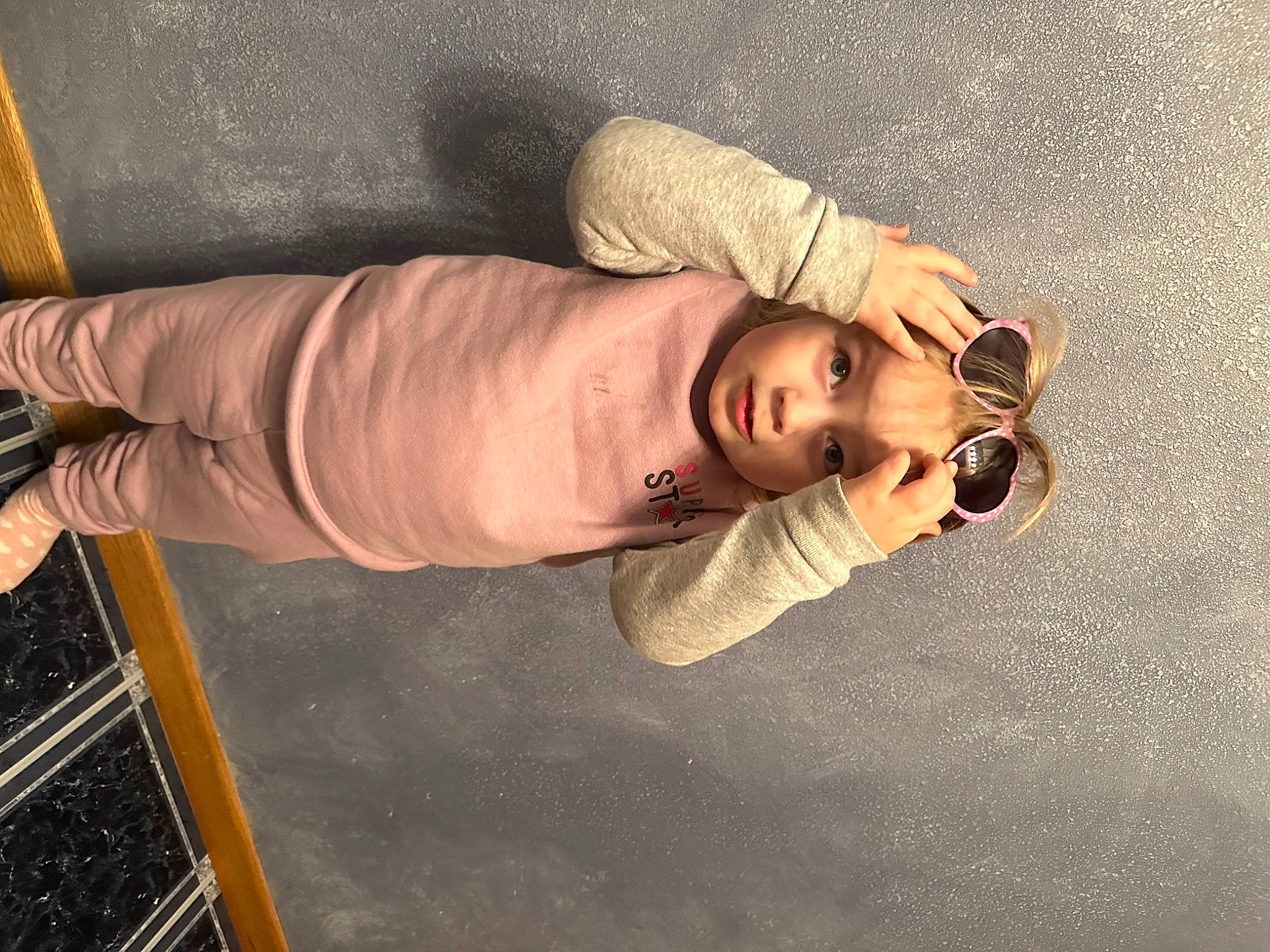 Noelle is registered to the contest to win money with this photo: chest, comfort, elbow, eyelash, eyewear, fun, headwear, human_leg, person, sleeve, thigh, wood