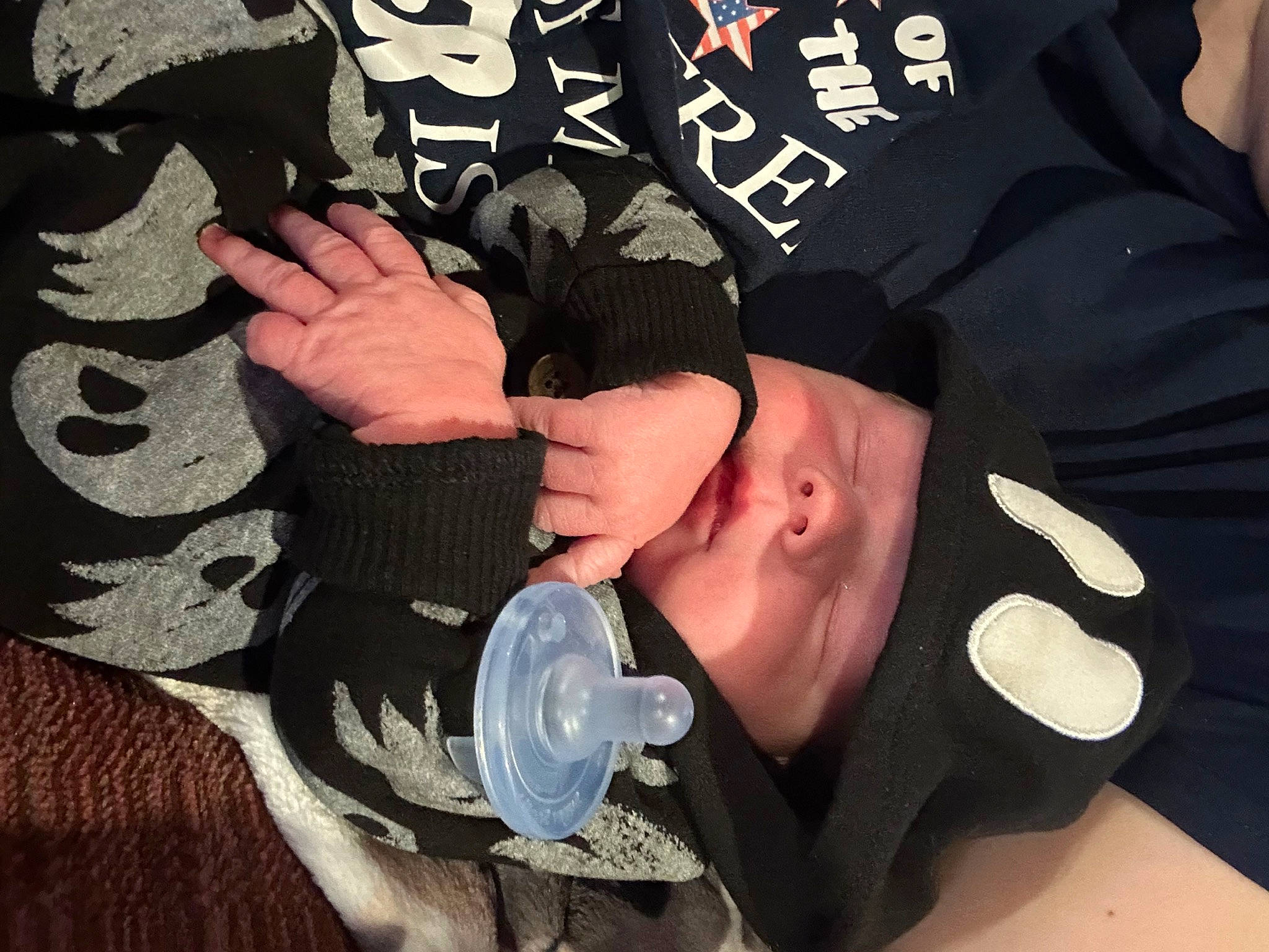 Charles is registered to the contest to win money with this photo: audio_equipment, cap, chest, child, cool, elbow, finger, flesh, font, gesture, glove, hat, nail, pattern, person, personal_protective_equipment, sleeve, t_shirt, thigh, thumb