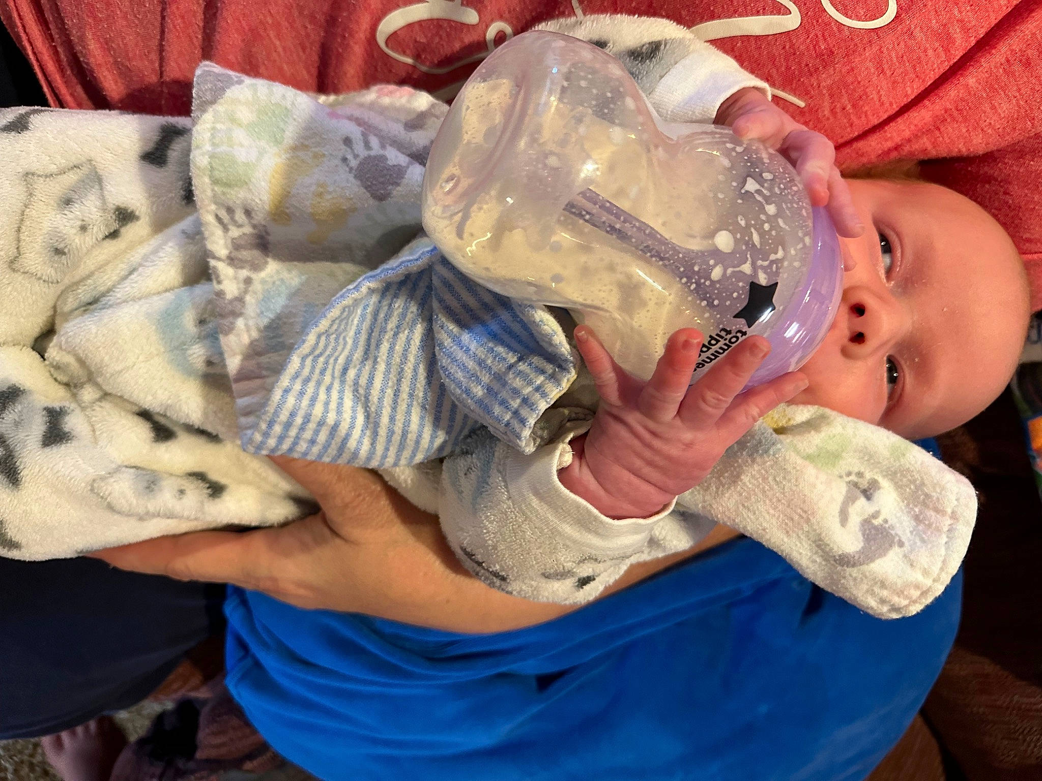 Charles is registered to the contest to win money with this photo: baby, baby_toddler_clothing, child, comfort, drinking, drinkware, fashion_accessory, flesh, happy, hat, nail, pattern, person, personal_protective_equipment, plastic, plastic_bottle, service, sitting, smile, toddler