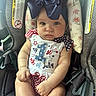 Harper is registered to the contest to win money with this photo: baby, child, car_seat, headband, bow, clothing, infant, patriotic, 4th_of_july, seatbelt, warning_label, floral_pattern, cute, chubby_cheeks, portrait, sitting, indoors, person, young_child, closeup