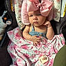 Harper is registered to the contest to win money with this photo: baby, pink_bow, blanket, car_seat, pacifier, plush_toy, penguin, child, infant, face, clothing, portrait, cute, indoor, seatbelt, headwear, expression, soft_toys, fabric, comfort