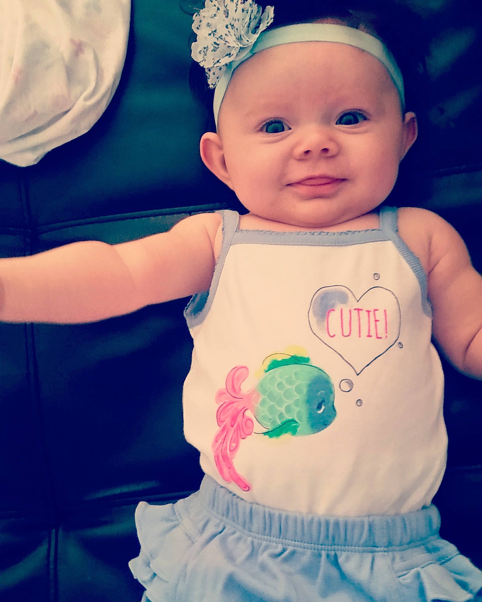 Ivey is registered to the contest to win money with this photo: blue, child, dress, infant, organ, person, skin, smile, sweetness, toddler