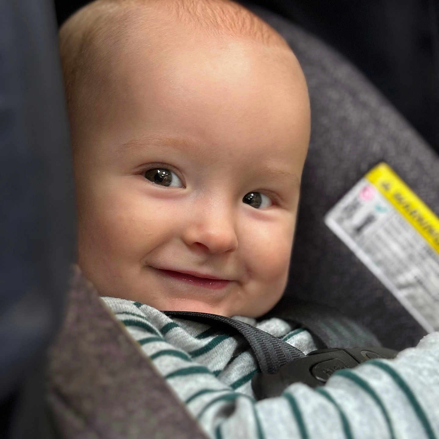 Daniel joined the competition — help win amazing prizes! baby, child, smiling, face, car_seat, seatbelt, striped_clothing, closeup, infant, cute, happy, portrait, safety, seat, person, young_child, head, eyes, baby_clothes, indoors