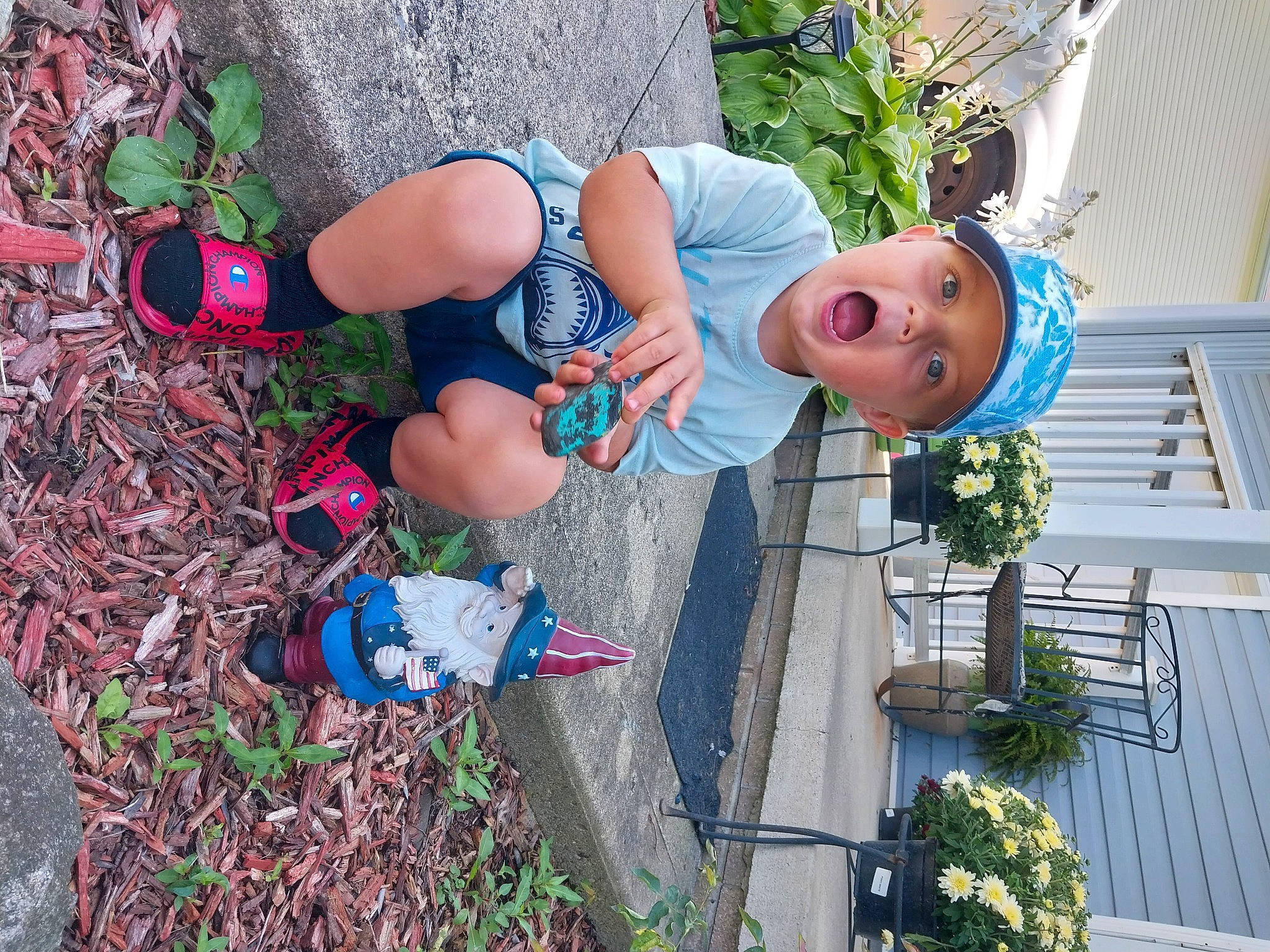 Lorenzo is registered to the contest to win money with this photo: blue, boot, electric_blue, flower, flowerpot, fun, grass, green, hat, headwear, houseplant, human_leg, leaf, leisure, people_in_nature, person, plant, recreation, smile, surprise