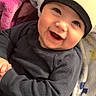 Knox joined the competition — help win amazing prizes! baby, smiling, beanie, clothing, blanket, infant, happy, face, child, warm, cozy, cute, portrait, apparel, soft, indoor, person, expression, comfort, colorful
