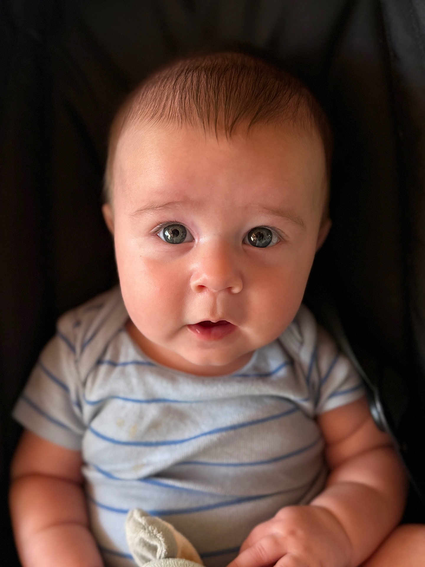 Graham Brewer is registered to the contest to win money with this photo: baby, child, face, portrait, close_up, eyes, chubby_cheeks, striped_clothing, infant, cute, person, skin, head, expression, soft_light, sitting, hand, young, adorable, baby_girl