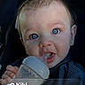 Miko is registered to the contest to win money with this photo: apparel, baby, blue_eyes, bottle, child, cute, drinking, face, hand, indoor, infant, lock_screen, message_notification, person, portrait, sitting, smartphone, text, toddler, young_child