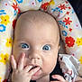 baby, blue_eyes, car_seat, child, close_up, clothing, curious, cute, expression, face, fingers, floral_pattern, hand, head, indoors, infant, portrait, seatbelt, sitting, skin