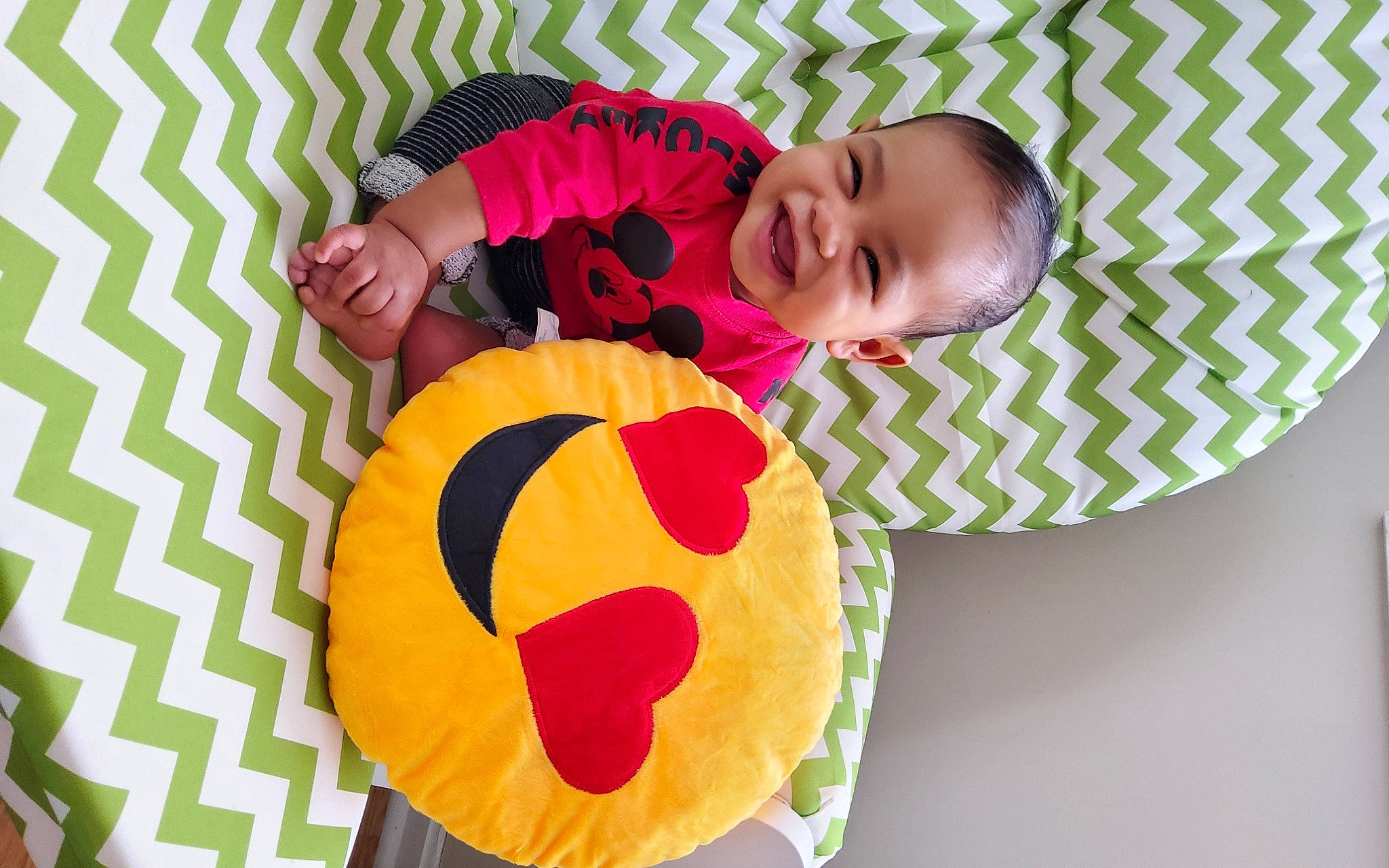 Ledger is registered to the contest to win money with this photo: baby, baby_toddler_clothing, child, comfort, face, fun, happy, joy, linens, magenta, mammal, orange, pattern, person, pink, plant, product, smile, textile, toddler