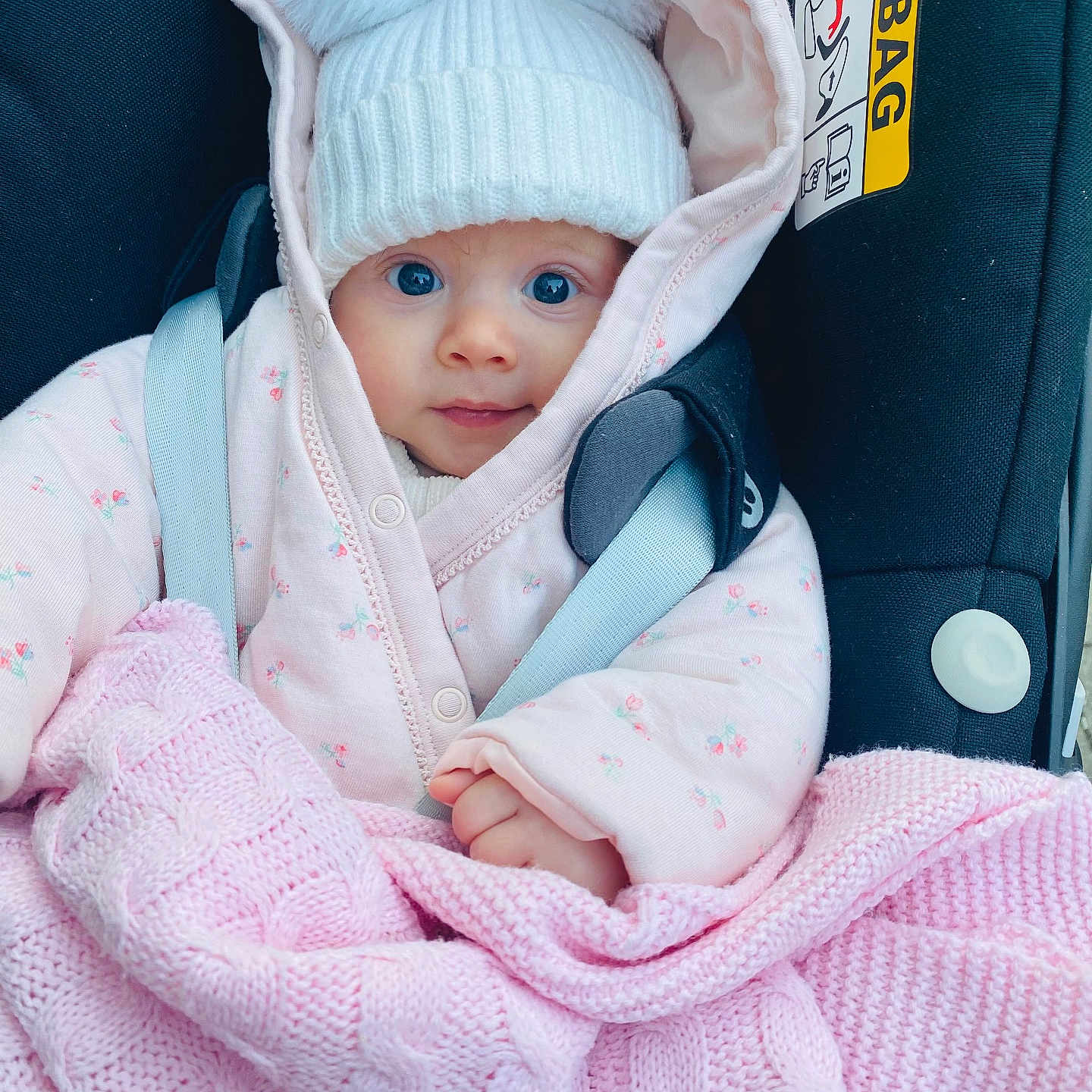 Elisa joined the competition — help win amazing prizes! baby, blanket, bonnet, cap, car, clothing, coat, face, hat, head, hood, jacket, knitwear, newborn, person, photography, portrait, sweater, transportation, vehicle
