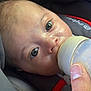 Arnaud a rejoint le concours — aidez-le/la à gagner de superbes lots ! baby, bottle, candid, car_seat, child, close_up, clothing, comfort, cute, eyes, face, feeding, hand, infant, milk, newborn, person, seatbelt, skin, young