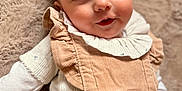 Victoire participe au concours pour gagner de l'argent avec cette photo : baby, infant, face, eyes, clothing, outfit, bow, ruffle, blanket, soft, cute, smile, lying, skin, head, hand, indoors, portrait, child, adorable
