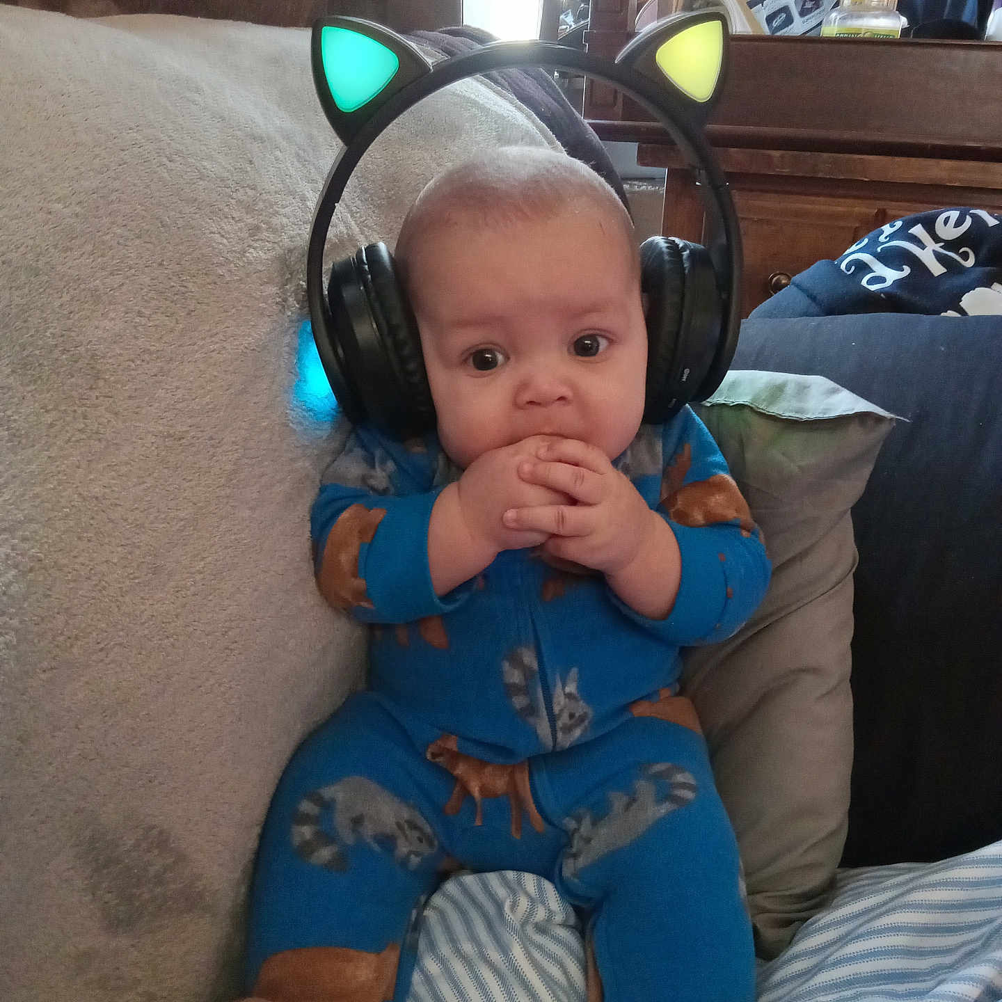 Sabastian is registered to the contest to win money with this photo: accessories, baby, bag, bodypart, couch, cushion, electronics, face, finger, furniture, hand, handbag, head, headphones, homedecor, person, photography, portrait, sitting, stereo