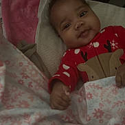 Ayen joined the competition — help win amazing prizes! baby, infant, crib, blanket, red_clothing, onesie, reindeer, smiling, face, child, bed, sleeping_area, pillow, cute, indoors, cozy, soft_lighting, portrait, young_child, happy