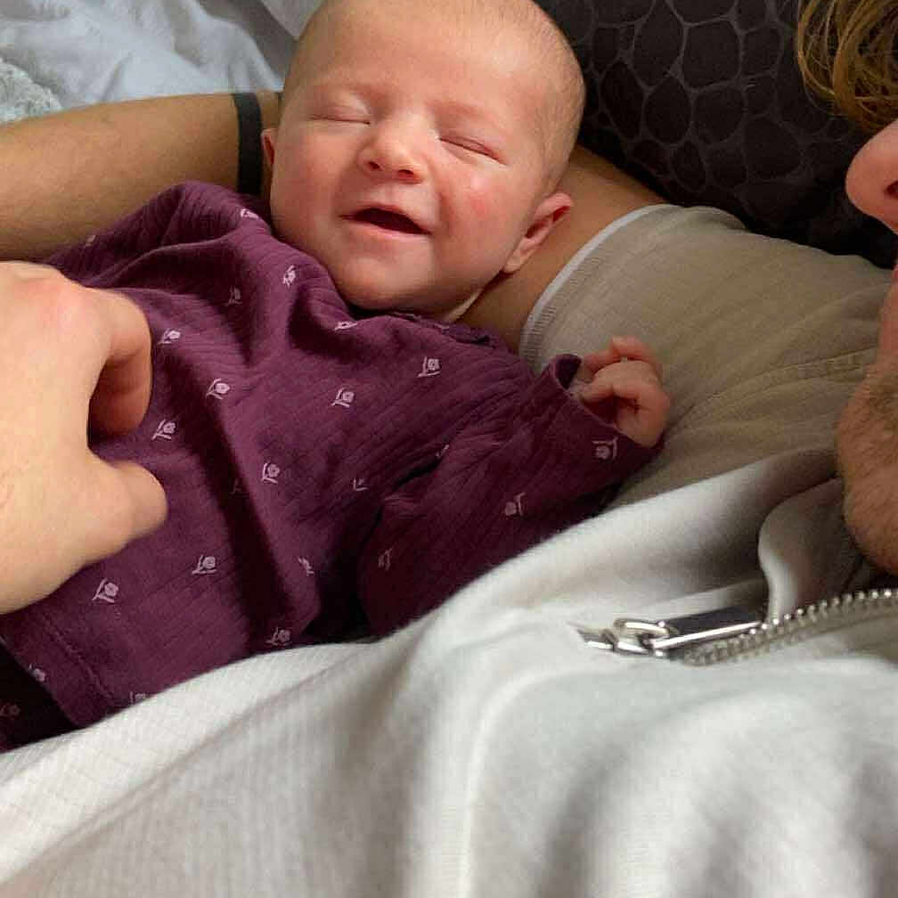 Isabella-Rose Fry is registered to the contest to win money with this photo: baby, bed, blanket, closeup, comfort, cozy, cute, family, hand, indoor, infant, newborn, person, pillow, portrait, purple_clothing, relaxed, resting, sleepy, smiling