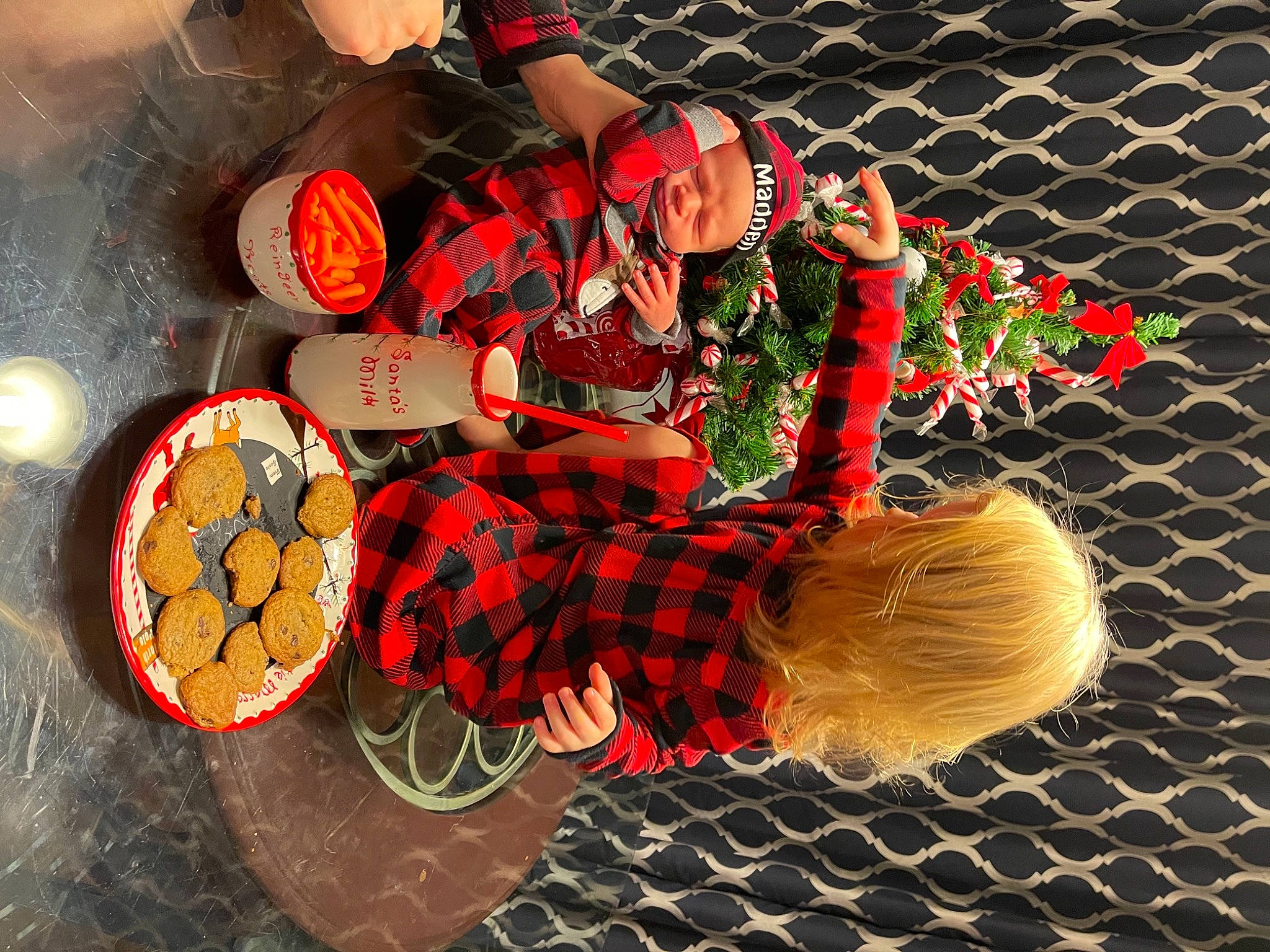 Madden joined the competition — help win amazing prizes! carmine, christmas, circle, event, fashion_accessory, hat, headwear, holiday, human_leg, icing, mesh, ornament, pattern, person, plaid, red, tartan, textile, tradition, wire_fencing
