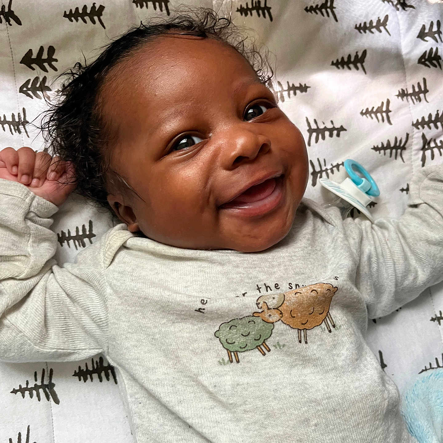 Zion is registered to the contest to win money with this photo: baby, babylaughing, bed, blanket, bodypart, clothing, cushion, face, finger, furniture, hand, happy, head, homedecor, newborn, person, photography, portrait, smile, t_shirt