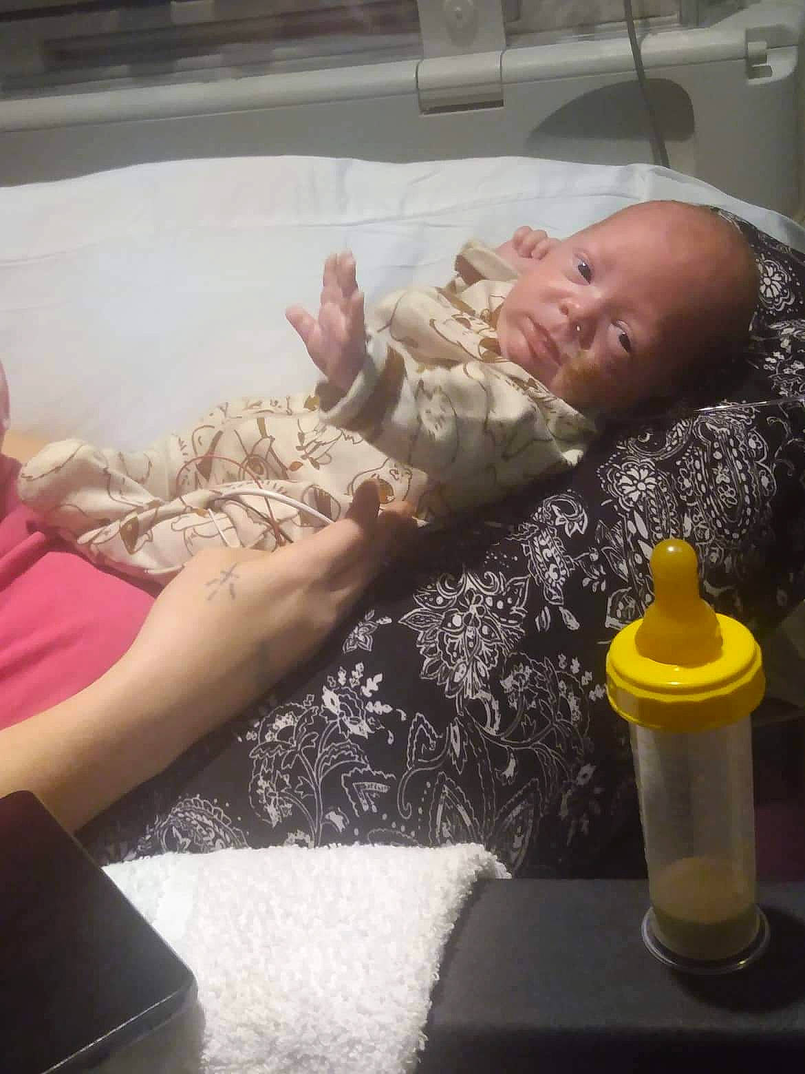 Cain joined the competition — help win amazing prizes! baby, child, comfort, drinkware, flesh, fun, gesture, mouth, nail, person, plastic, plastic_bottle, room, sitting, skin, t_shirt, table, tableware, thumb, toddler