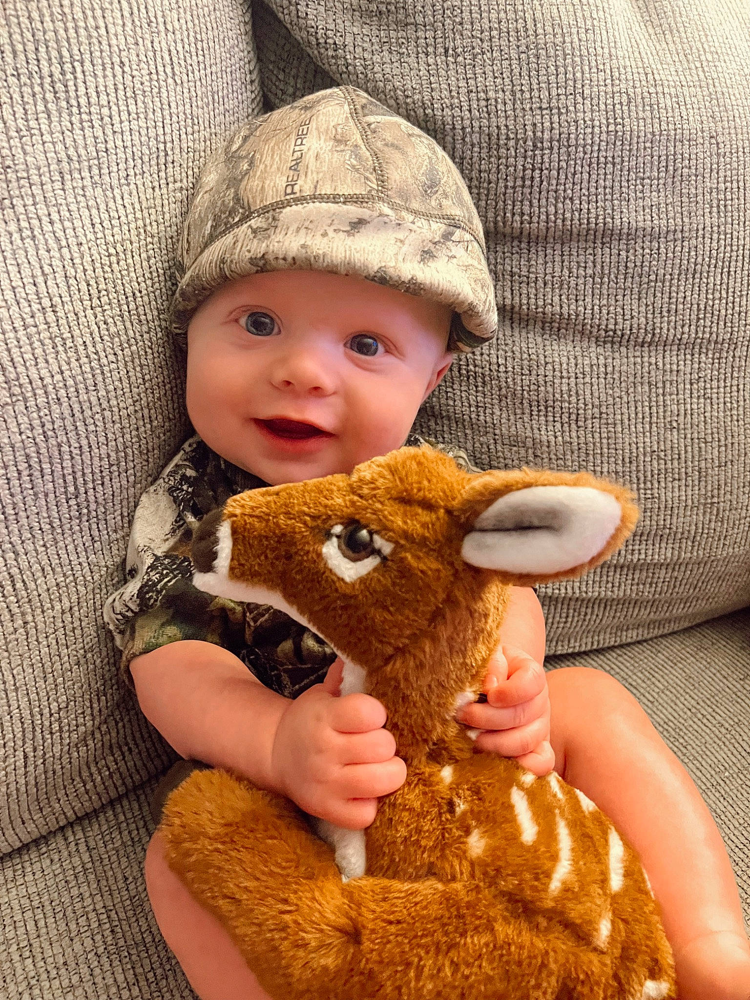 Levi is registered to the contest to win money with this photo: baby, cap, dress, ear, eye, face, fawn, finger, hand, happy, headgear, headwear, human_body, lip, mammal, nose, outerwear, person, skin, textile