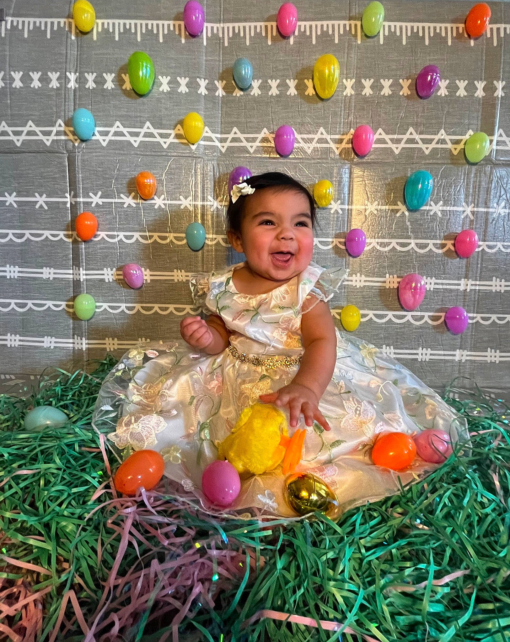 Ariel is registered to the contest to win money with this photo: baby, baby_toddler_clothing, ball, child, doll, easter, event, fun, grass, happy, hay, holiday, party, party_supply, people_in_nature, person, play, recreation, sitting, toddler