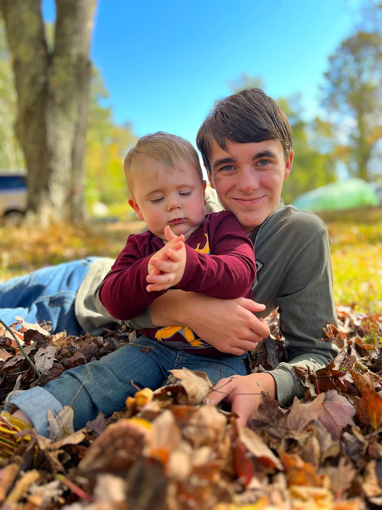 Malakai joined the competition — help win amazing prizes! child, deciduous, event, face, fun, grass, happy, joy, landscape, leaf, leisure, people, people_in_nature, person, plant, recreation, sitting, sky, smile, toddler