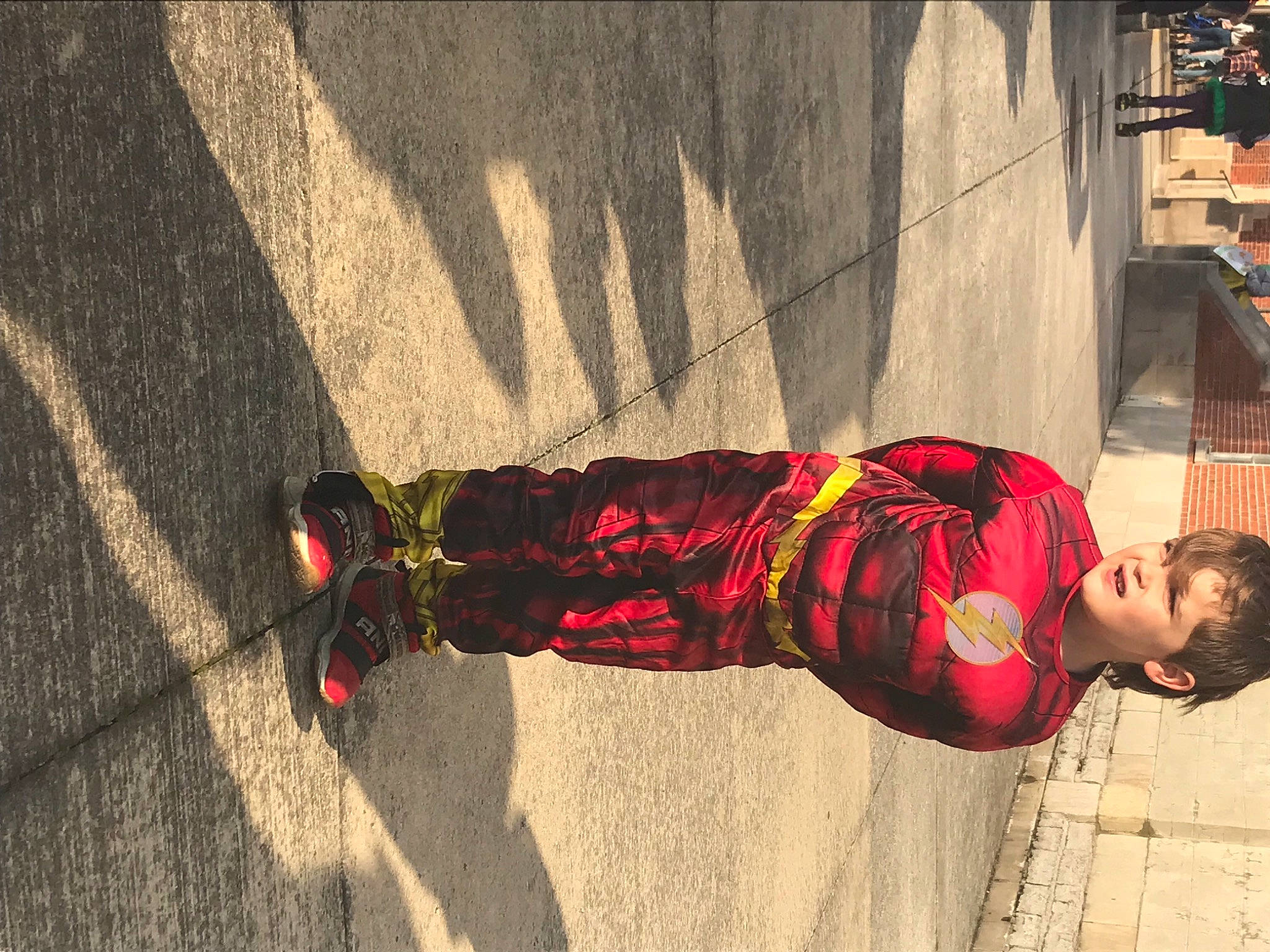 Dominic joined the competition — help win amazing prizes! asphalt, carmine, cobblestone, concrete, flooring, fun, human_leg, orange, pattern, pedestrian, person, plaid, road_surface, shadow, sidewalk, sitting, street, street_fashion, tints_and_shades, toddler