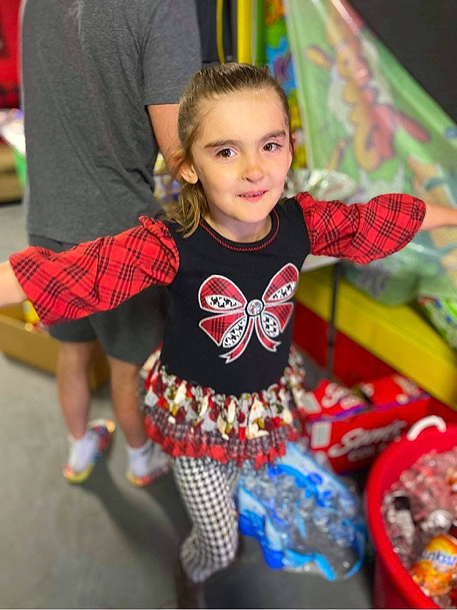 Savannah is registered to the contest to win money with this photo: child, dance, entertainment, event, fun, hairstyle, happy, human_leg, joy, leisure, pattern, performing_arts, person, plaid, recreation, sleeve, sock, sportswear, t_shirt, textile