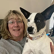 Amara joined the competition — help win amazing prizes! animal, blond_hair, casual_clothing, collar, companionship, couch, dog, friendship, glasses, happy, human, indoor, living_room, natural_light, pet, portrait, seated, smiling, window, woman