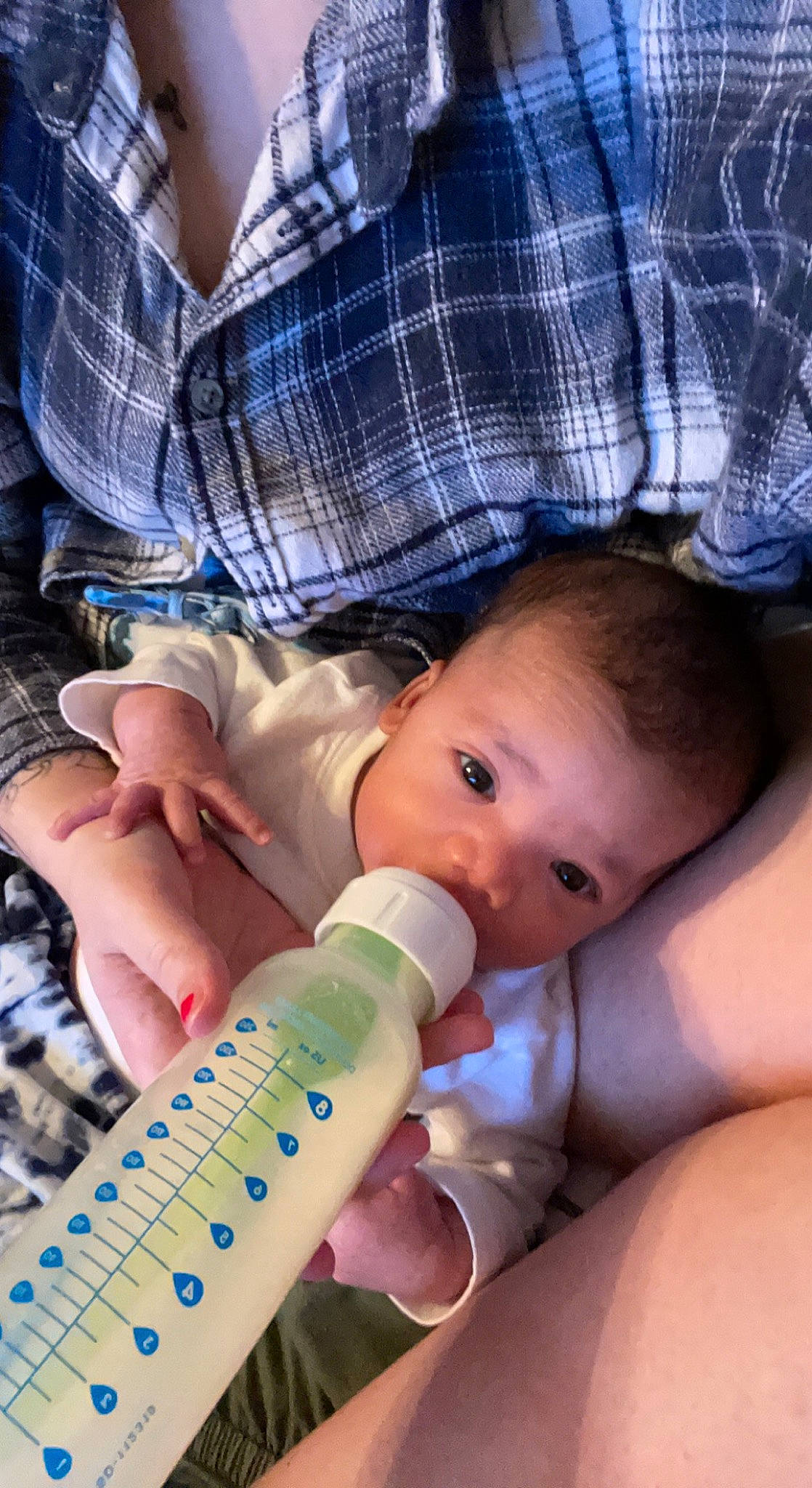 Dante is registered to the contest to win money with this photo: baby, baby_bottle, bottle, cheek, drinkware, eye, eyelash, face, finger, hand, head, iris, lip, nail, nose, person, plastic_bottle, product, skin, tartan