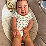 baby, infant, smiling, sitting, plush_toy, giraffe, baby_seat, cushion, clothing, onesie, happy, cute, child, indoors, person, skin, face, hand, leg, footwear